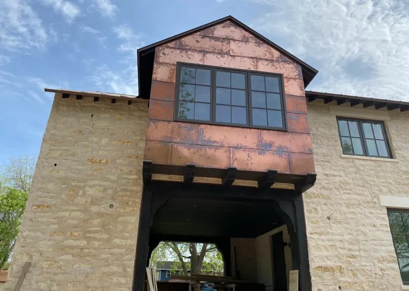 Copper metal panel facade on a stone building for Metal Roof Coating in Prairie Ridge